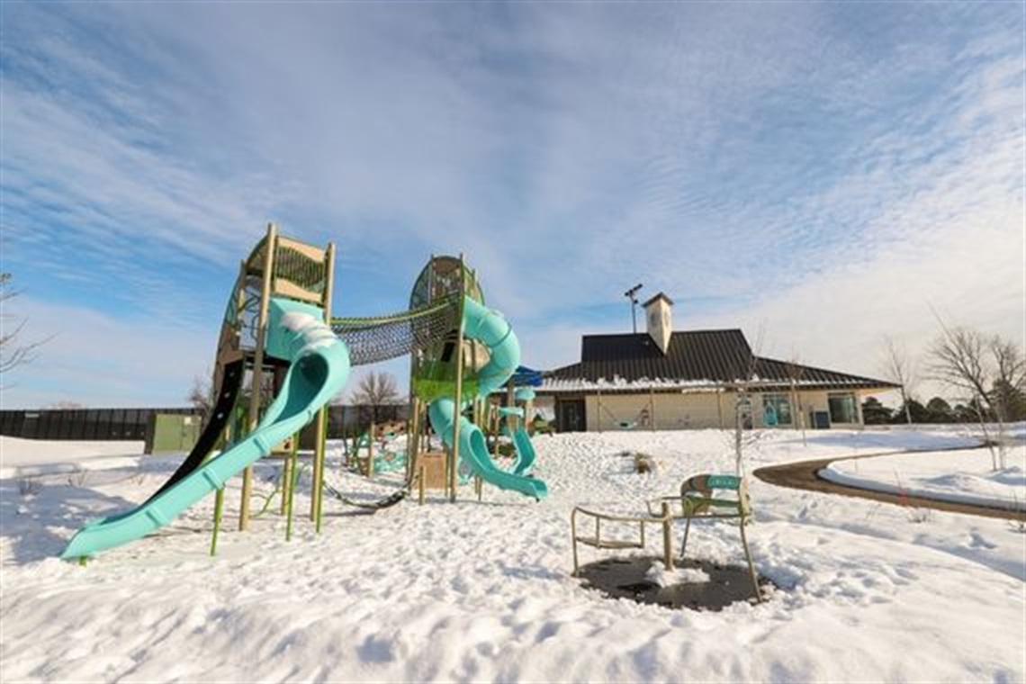 Snow covers the ground of Bobby Theisen's playground area